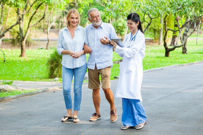woman and man visiting with doctor at one of the Tennessee pain clinics