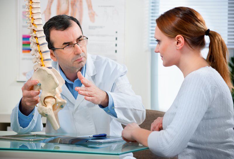 Pain management doctor talking to patient with Sacroiliitis