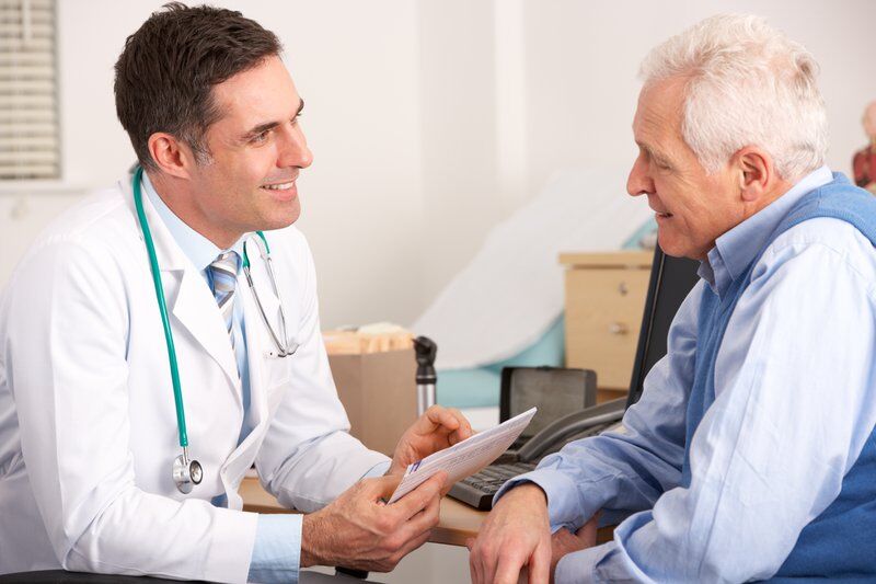 senior patient talking to doctor about chronic pain management