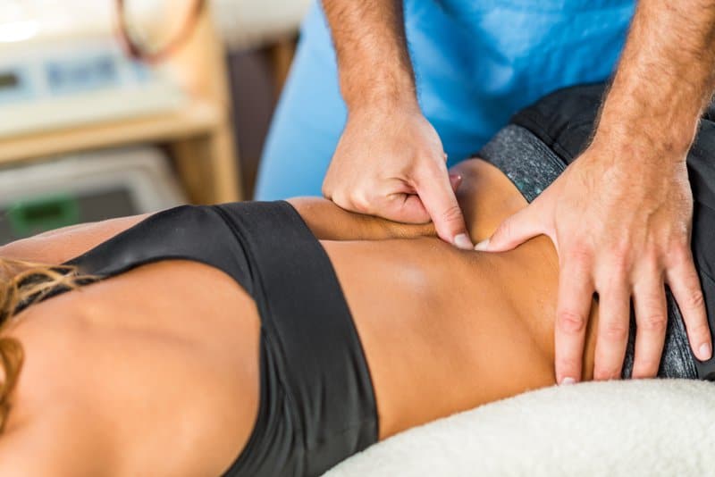 a massage therapist treating lower back pain