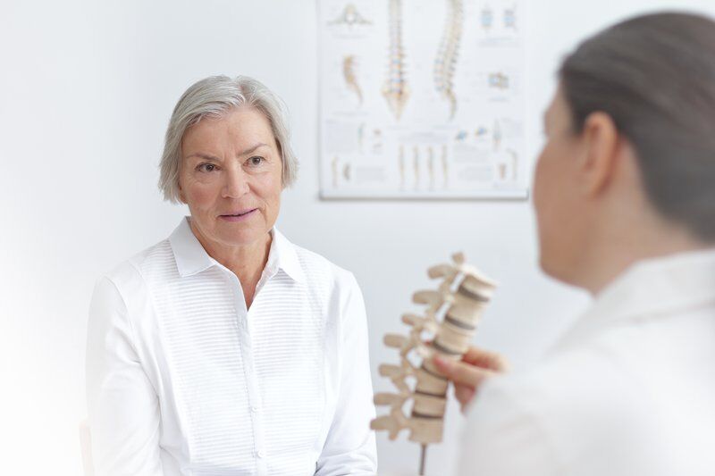 patient with back pain and doctor