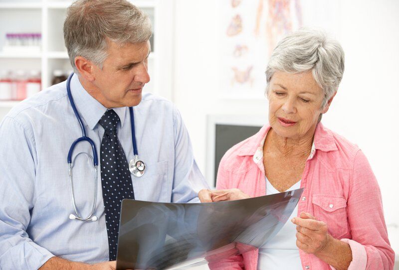comprehensive pain specialist with patient and x-ray