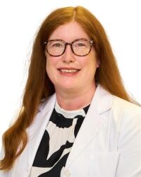 Erin Harrington, team member at MidSouth Pain Treatment Center, professional headshot in a white lab coat.